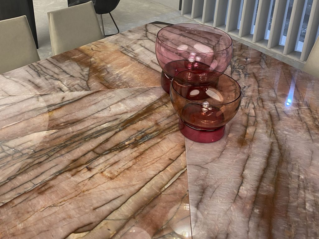 Pink and orange stone table top with glass vases